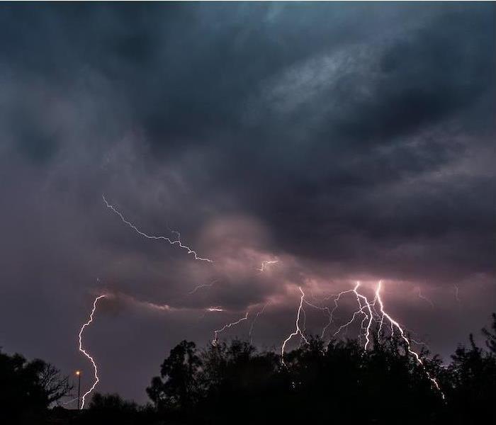 multiple lightning strikes occurring in a dark stormy sky