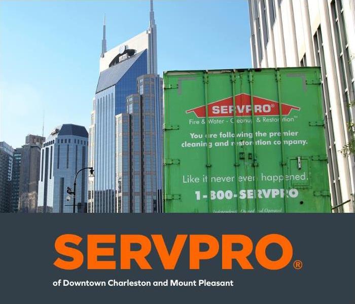 A SERVPRO of Downtown Charleston and Mount Pleasant Semi parked outside multiple sky scrapers