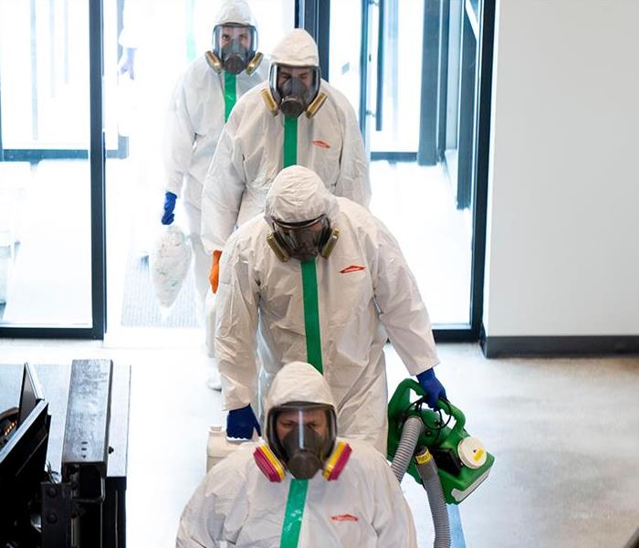 SERVPRO Technicians in PPE entering building 